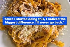 A plate of pasta with grated cheese.