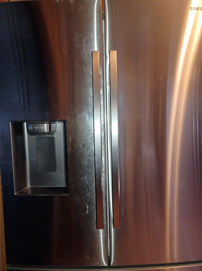 a reviewer photo of  steel fridge with one half clean and the other smudge