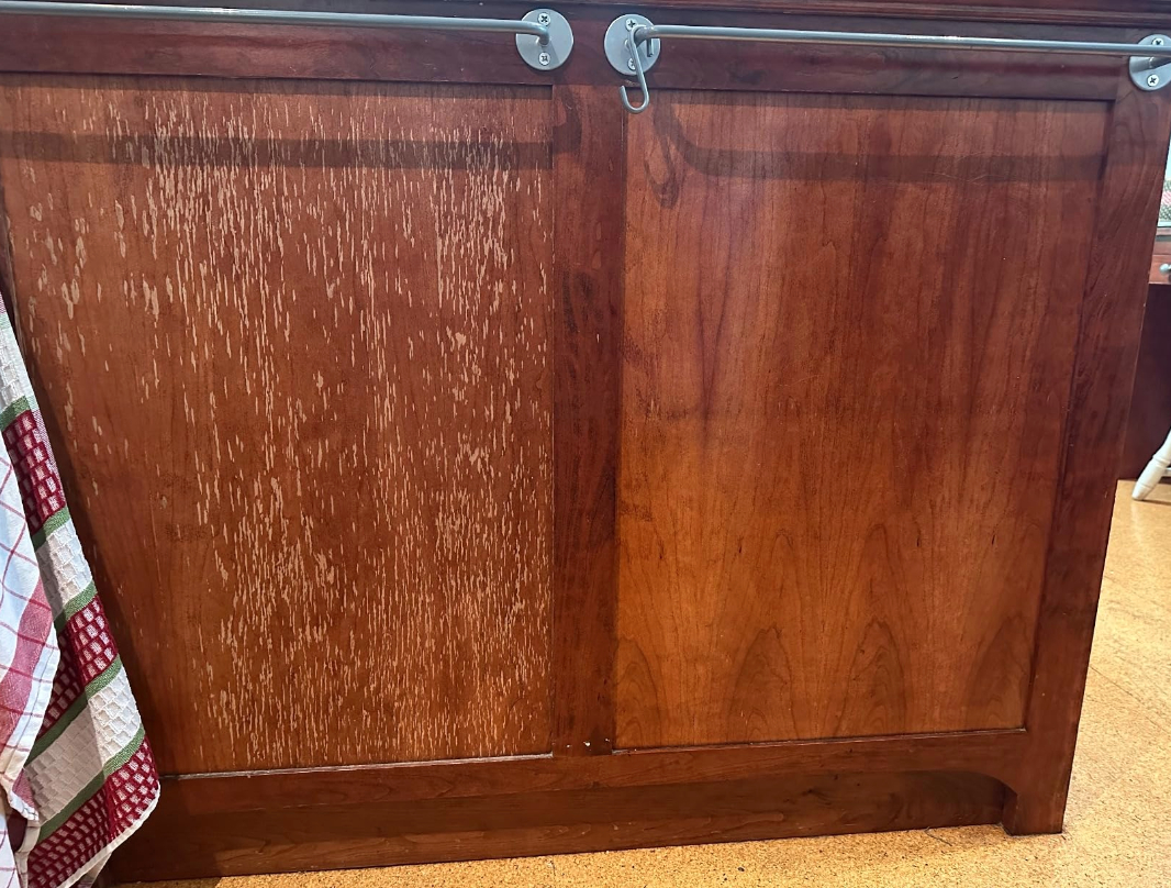 a reviewer photo of a wooden cabinet half polished with one side shiny the other side rough