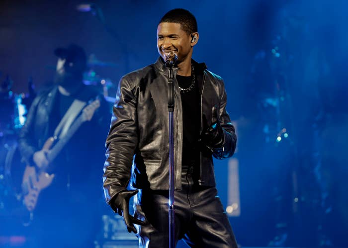 Closeup of Usher smiling as he performs onstage