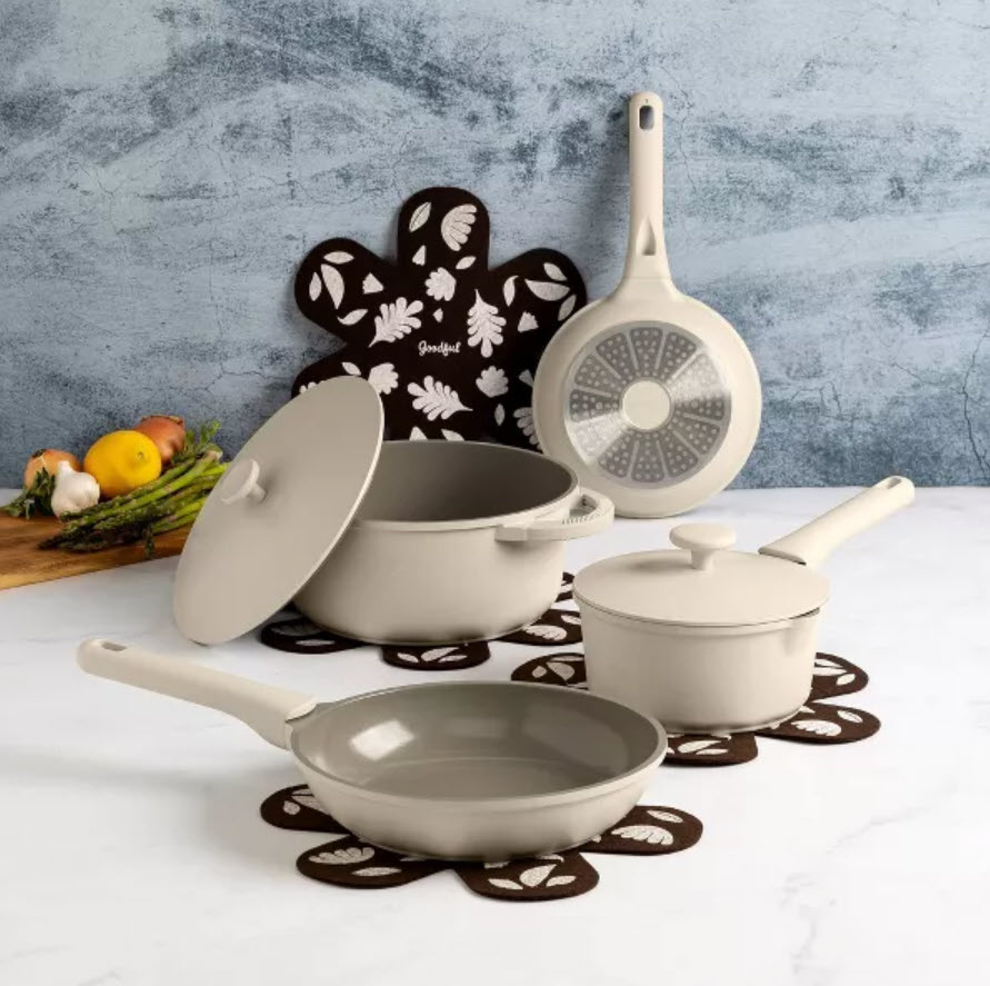 set of cream cookware set on countertop