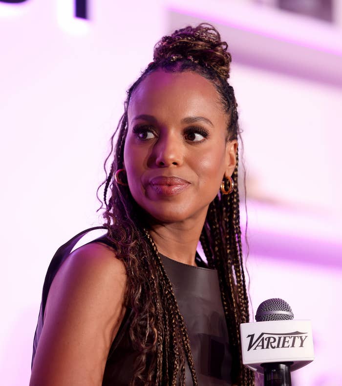 A closeup of Kerry Washington holding a microphone and looking off to the side
