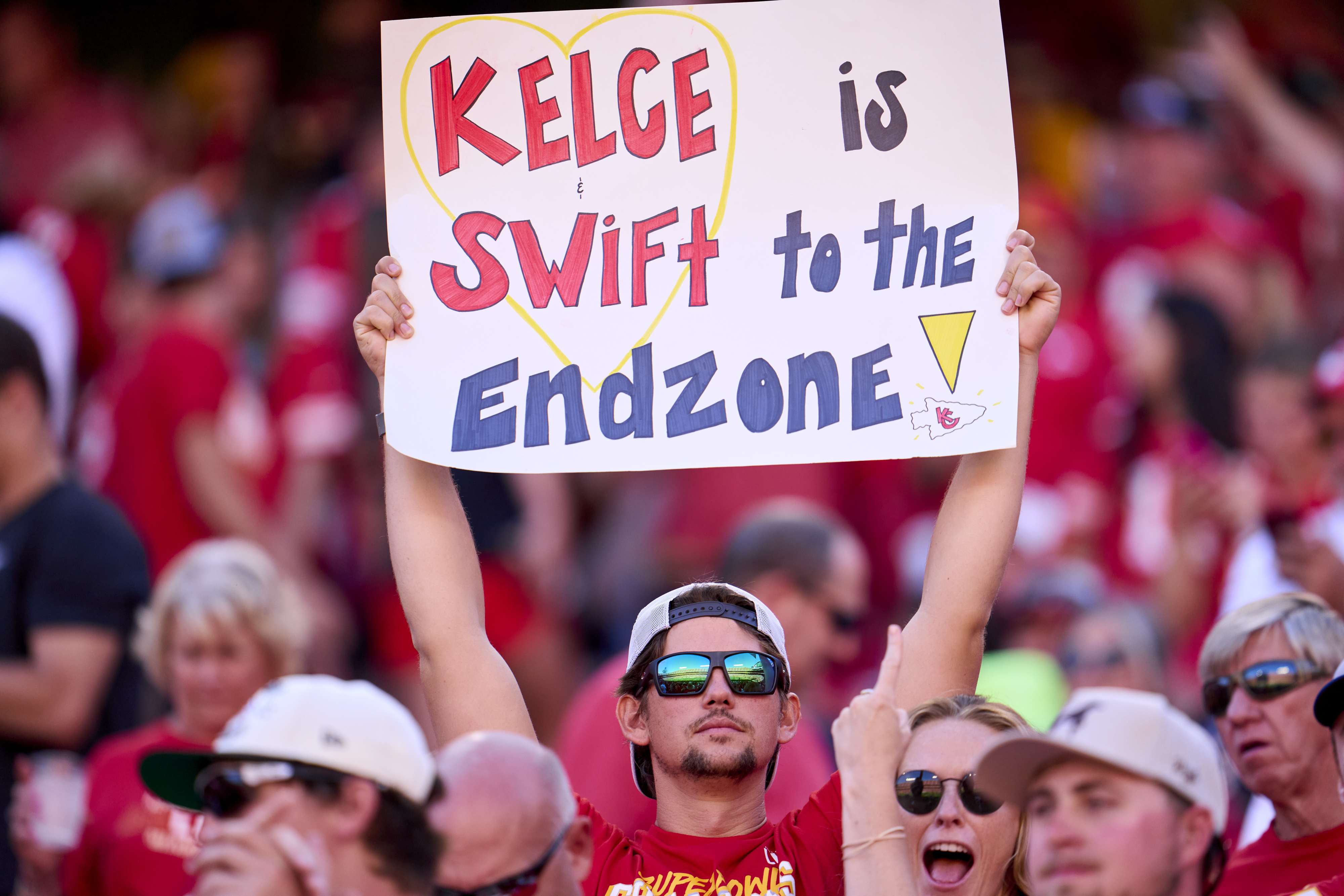 A fan holding a sign that says &quot;Kelce is Swift to the Endzone!&quot;