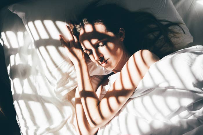 A woman sleeping with the sunlight on her