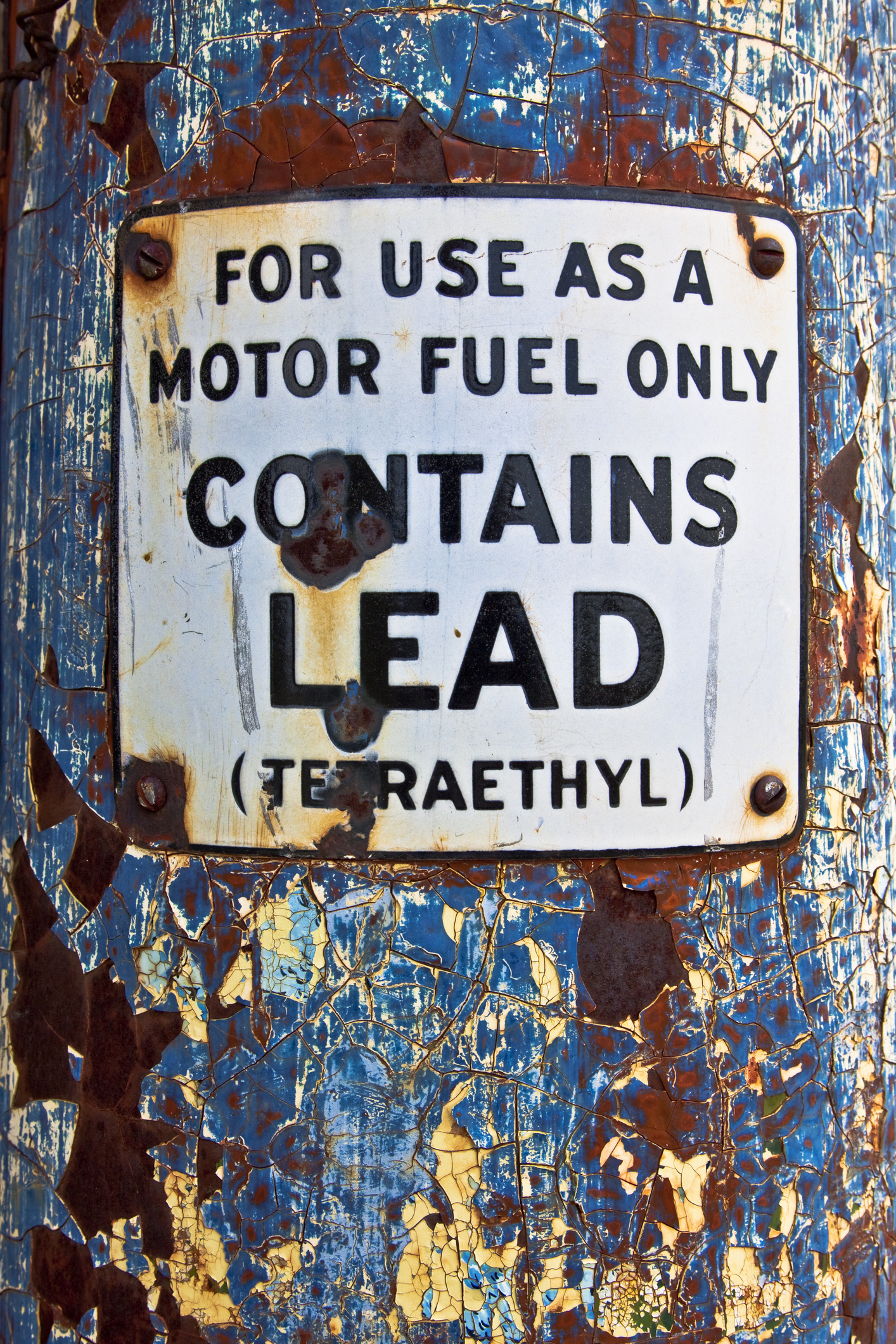 A sign saying gasoline contains lead