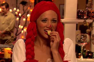 Anne from Parks and Rec eating an apple while dressed as Raggedy Anne