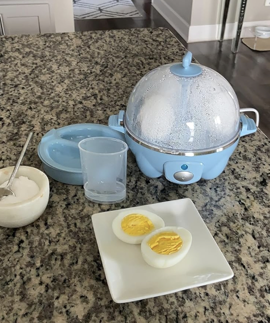 egg cooker and hard boiled egg on table