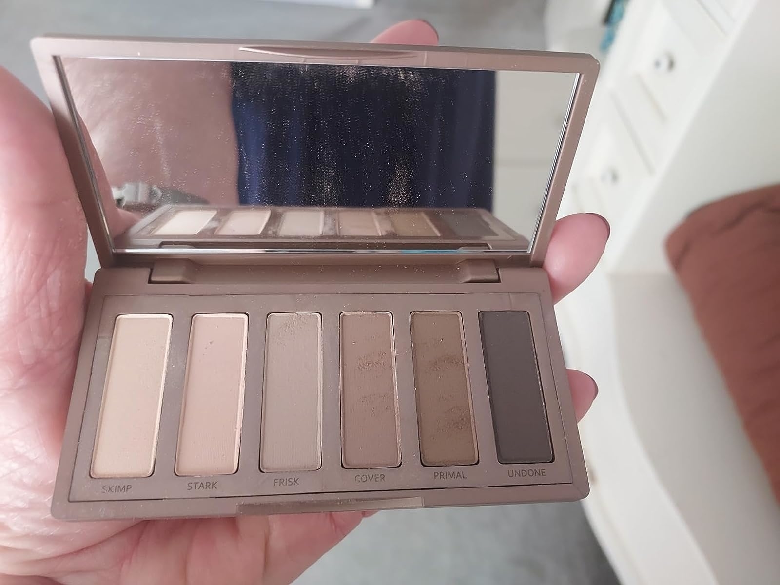 a reviewer holding their naked2 basic palette