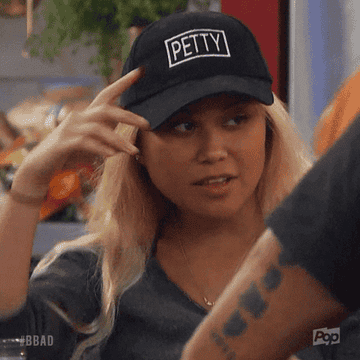 A woman tipping her hat down that says "Petty"