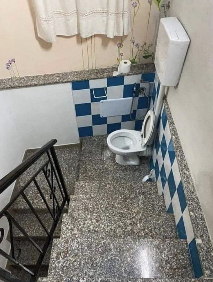 A toilet in the middle of a stairwell