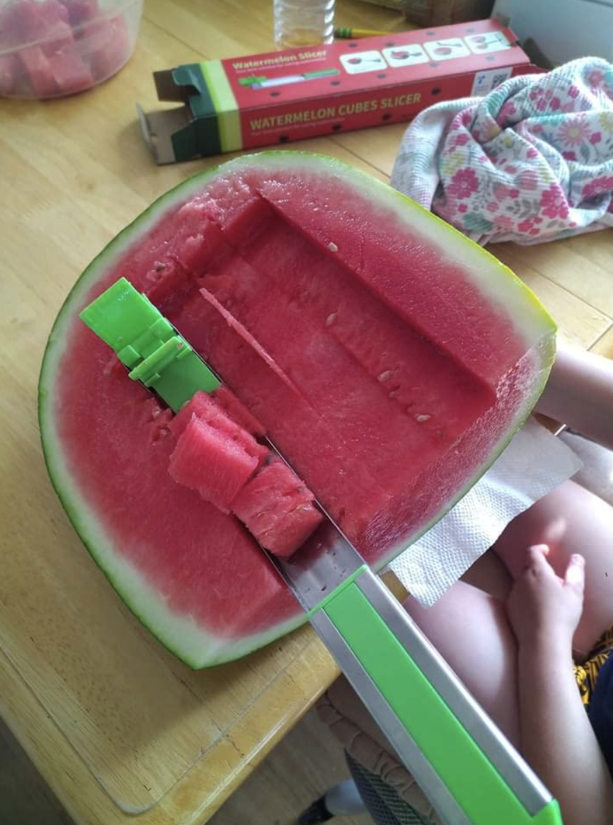 knife cutter in halved watermelon