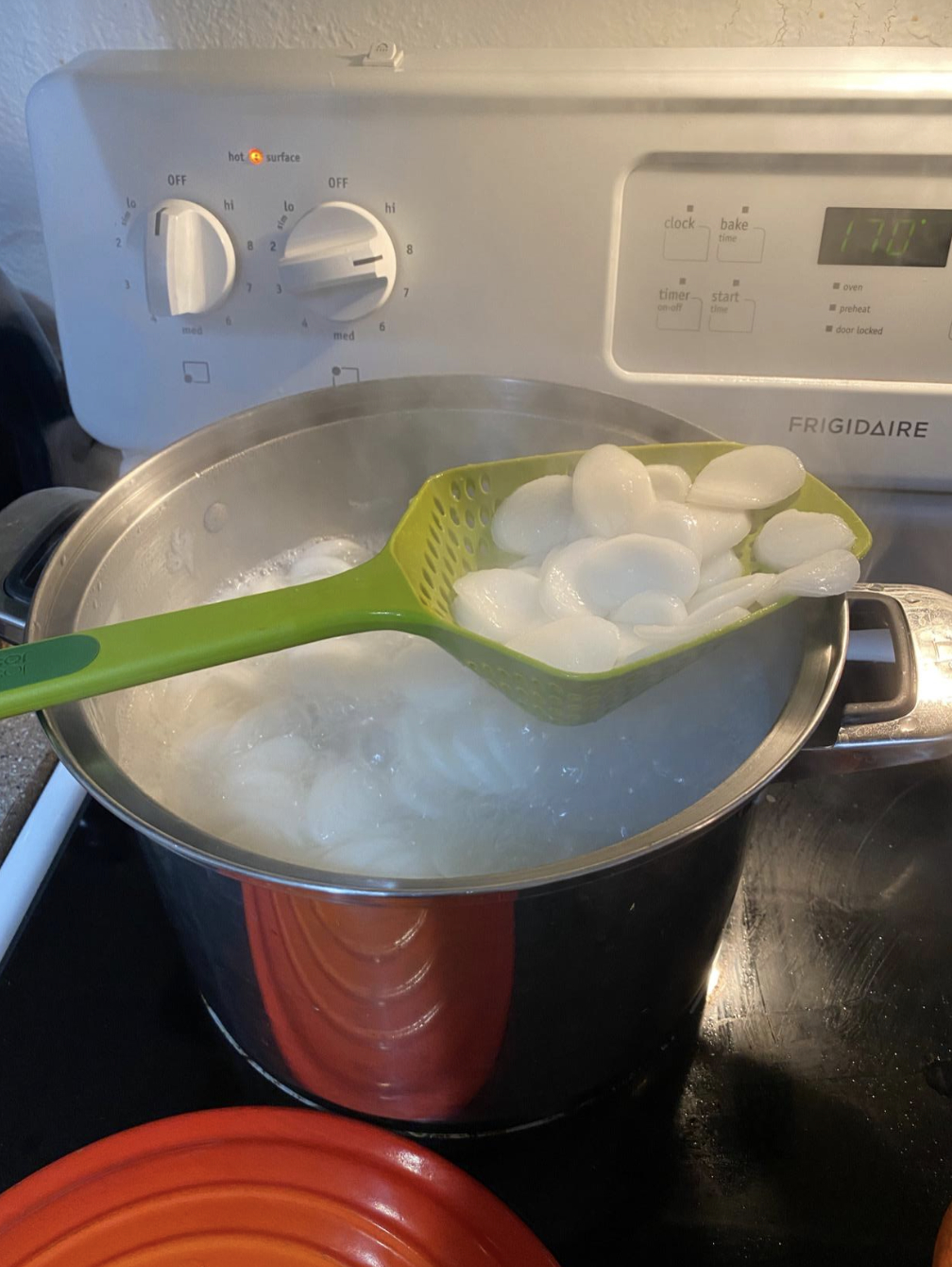 spoon strainer scooping straight from boiling pot