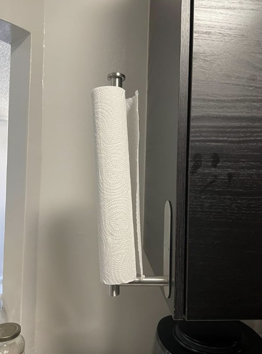 paper towel on holder attached to side cabinet