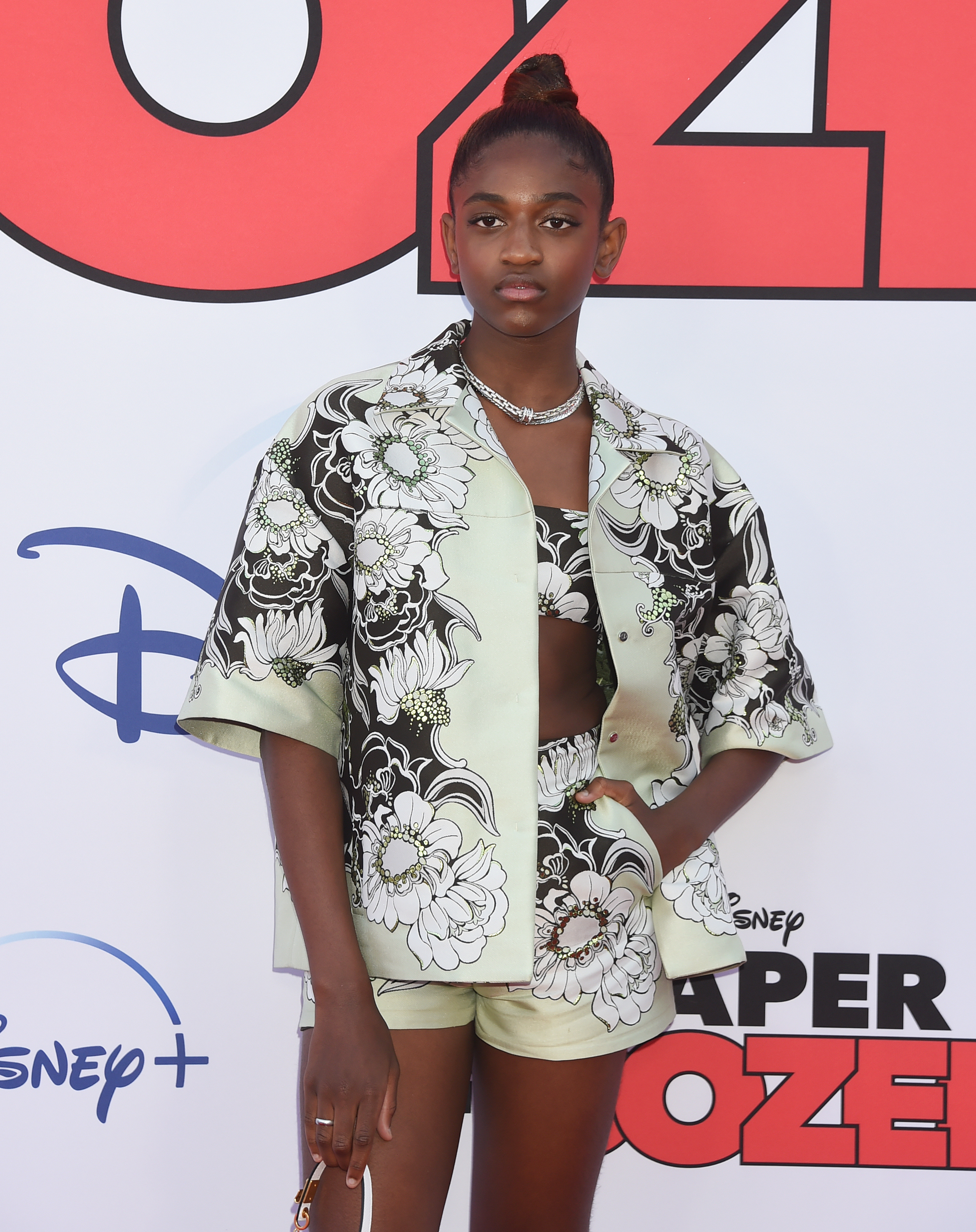 Closeup of Zaya Wade on the red carpet in a crop top and shorts with a matching jacket