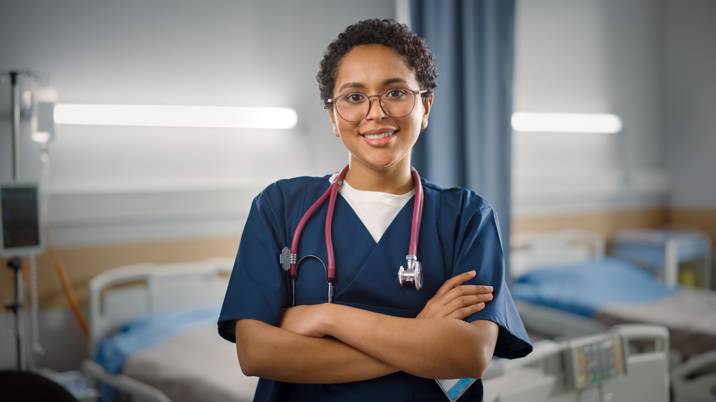 A nurse with a stethoscope smiling at the camera