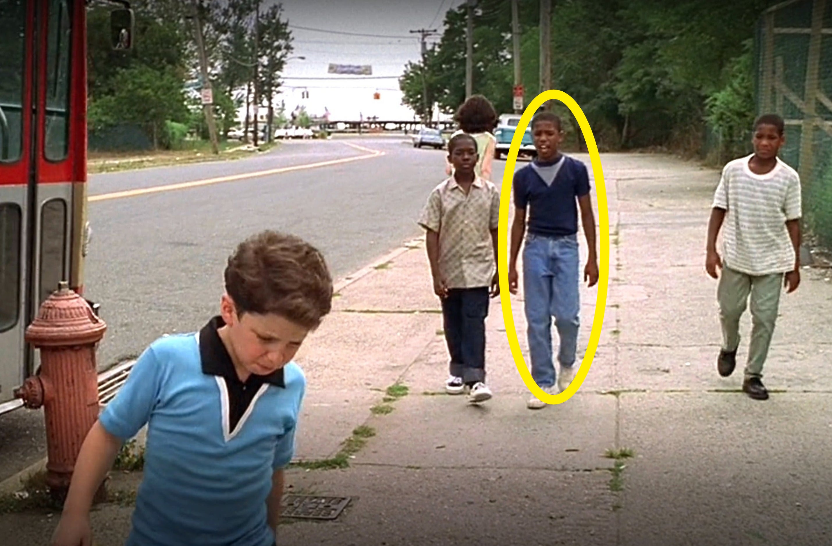 A young Michael circled and walking down the street with several other boys