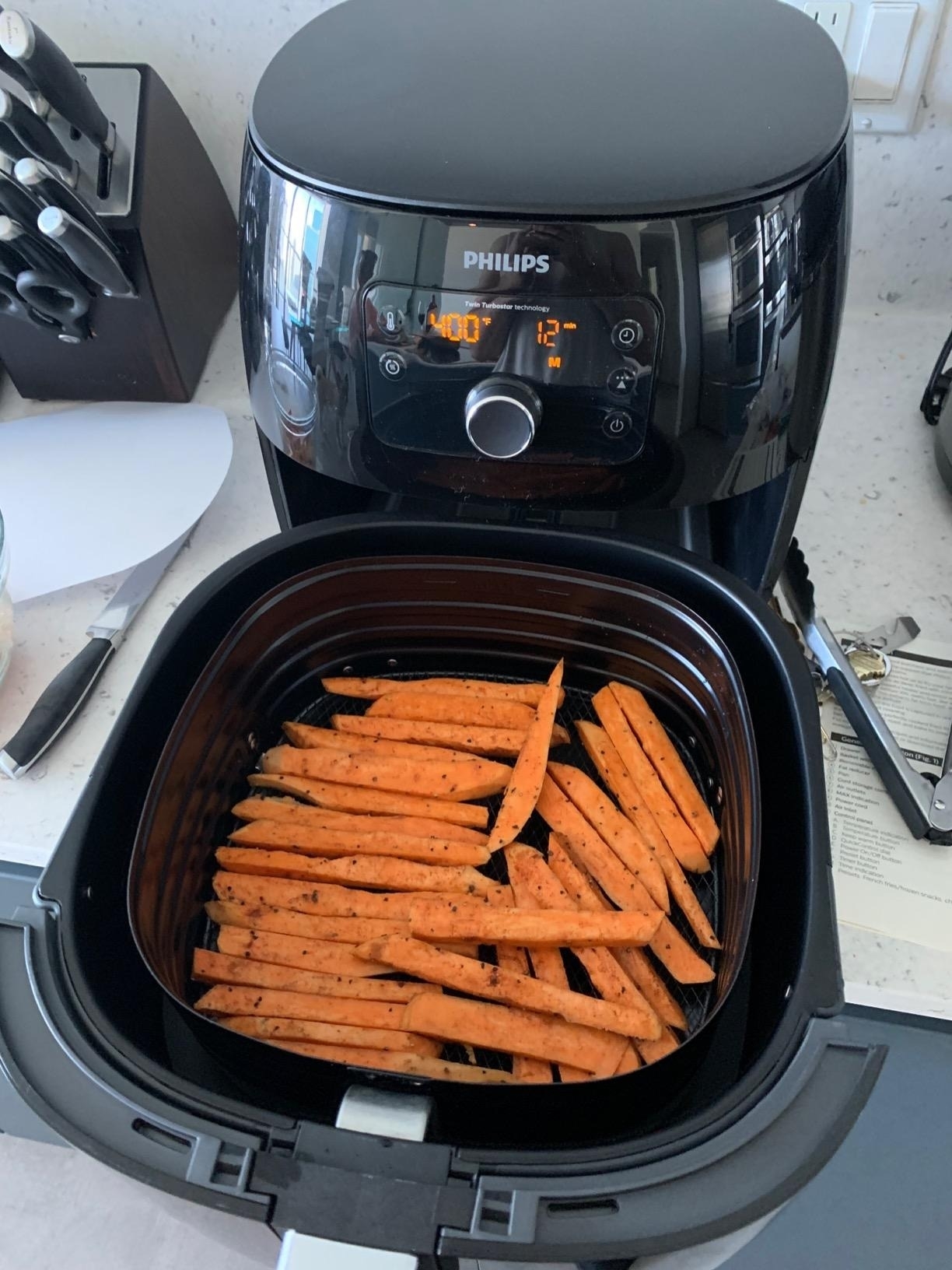 reviewer image of the air fryer with food in the basket