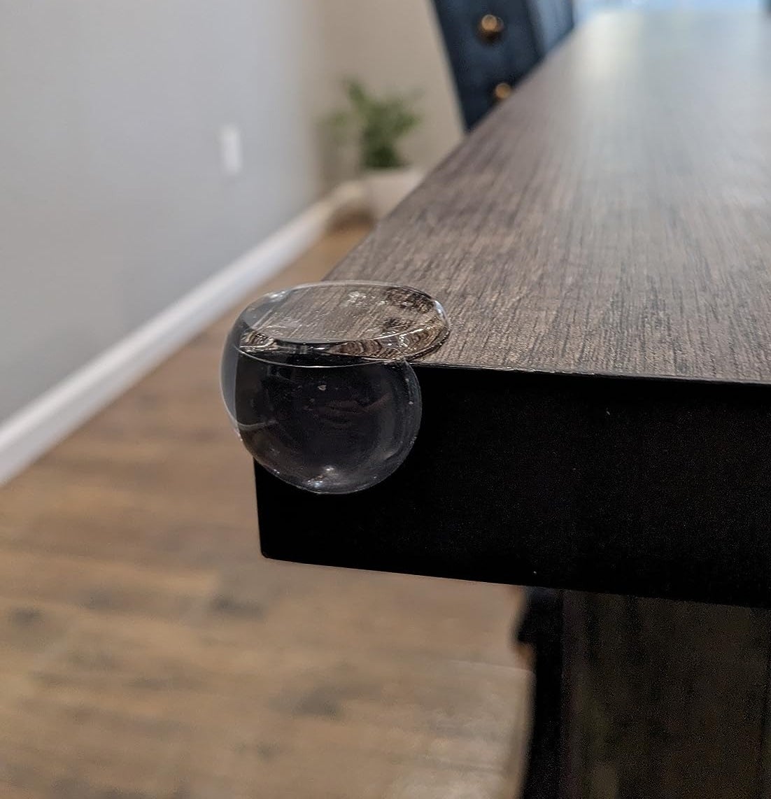 a reviewer photo of the corner protector on a table