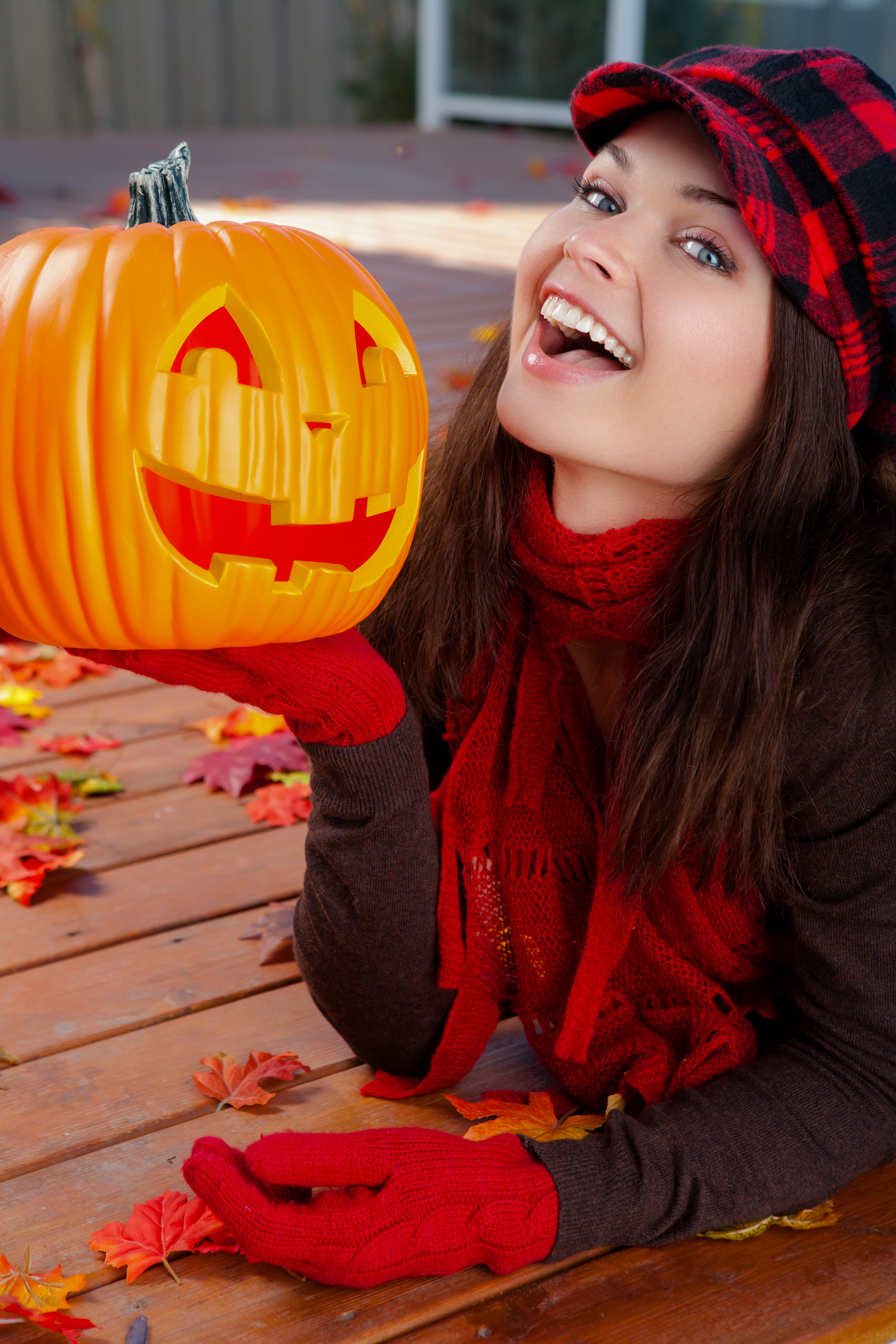 A woman posing with a pumpkin