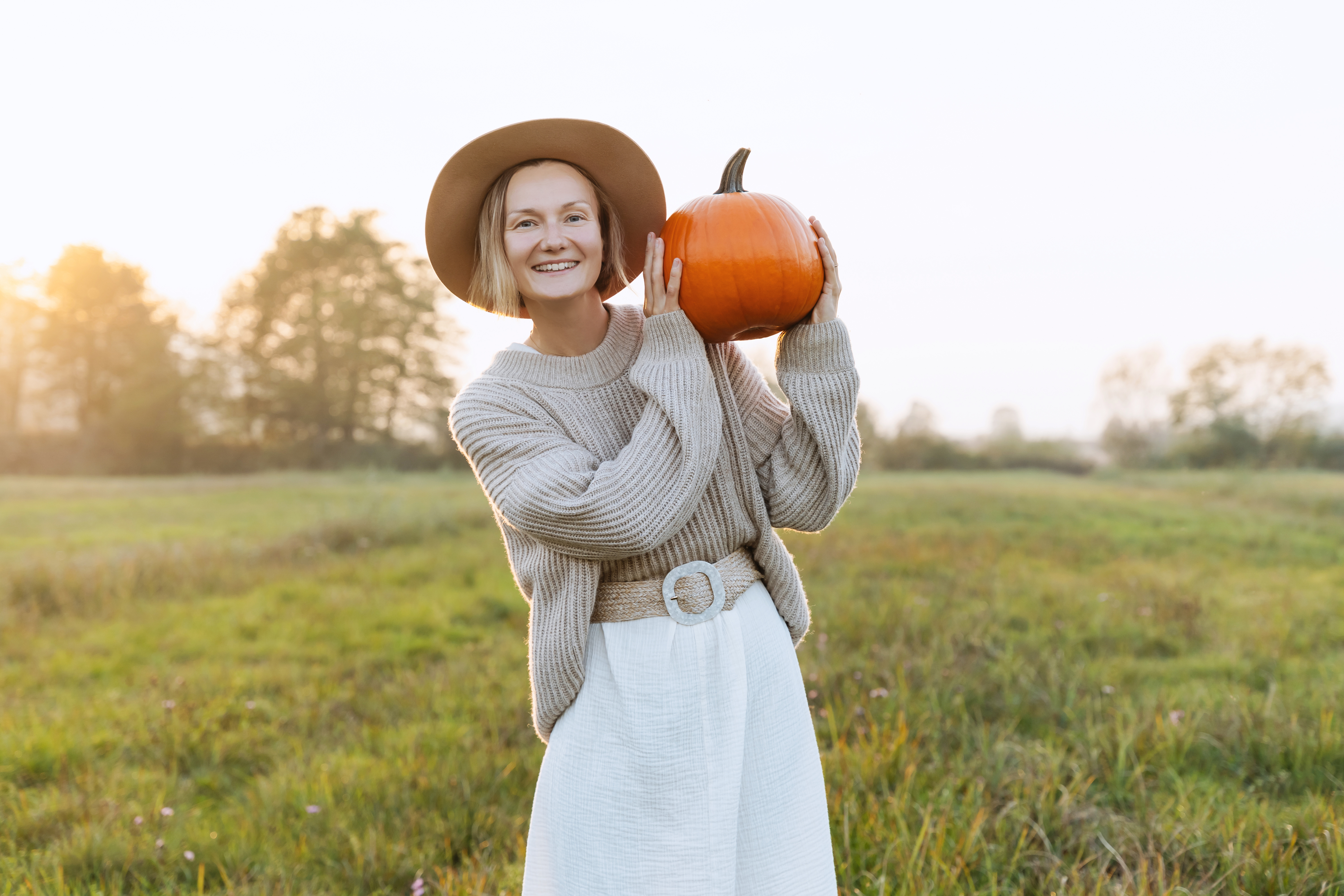 A woman holding a pumpkin