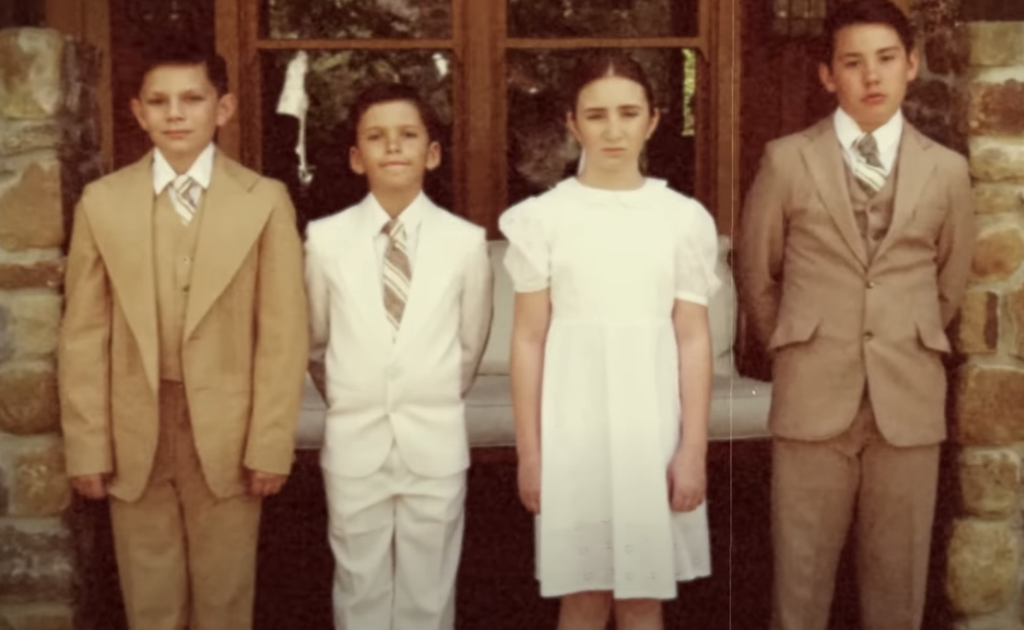 Kids standing in a row wearing dressy clothes