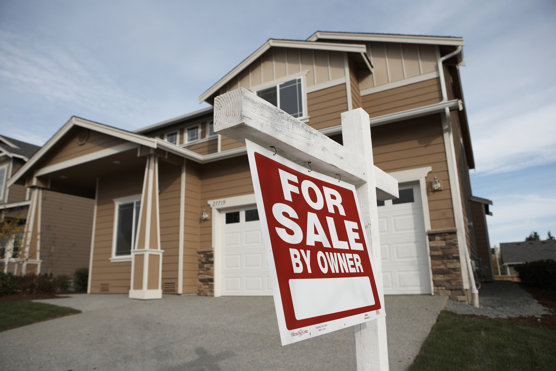 A for sale sign in front of a house