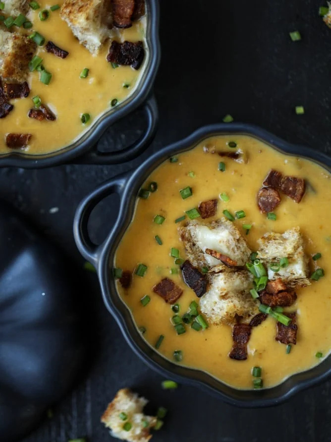 pumpkin bisque topped with grilled cheese croutons, chives, and bacon