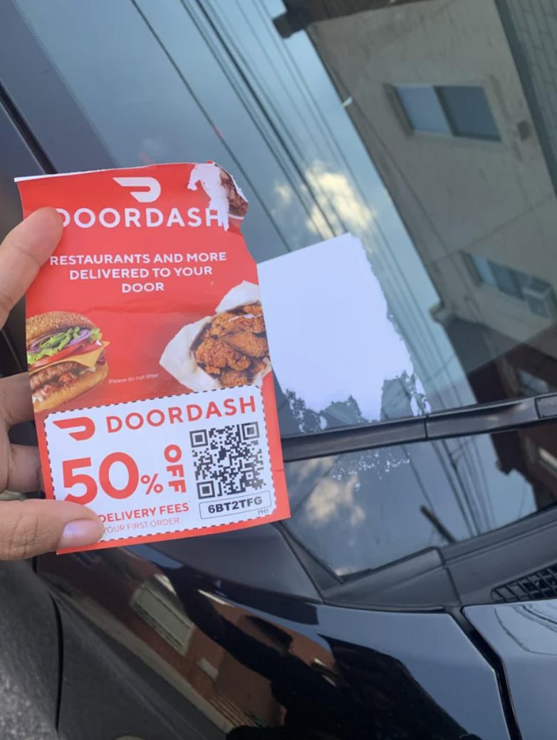 A DoorDash coupon on a windshield