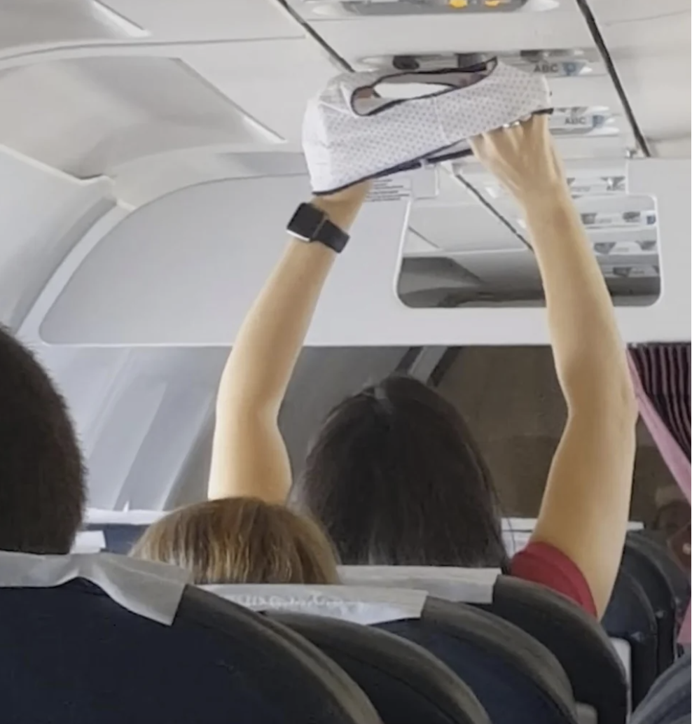 woman putting up a pair of underwear to the air vent