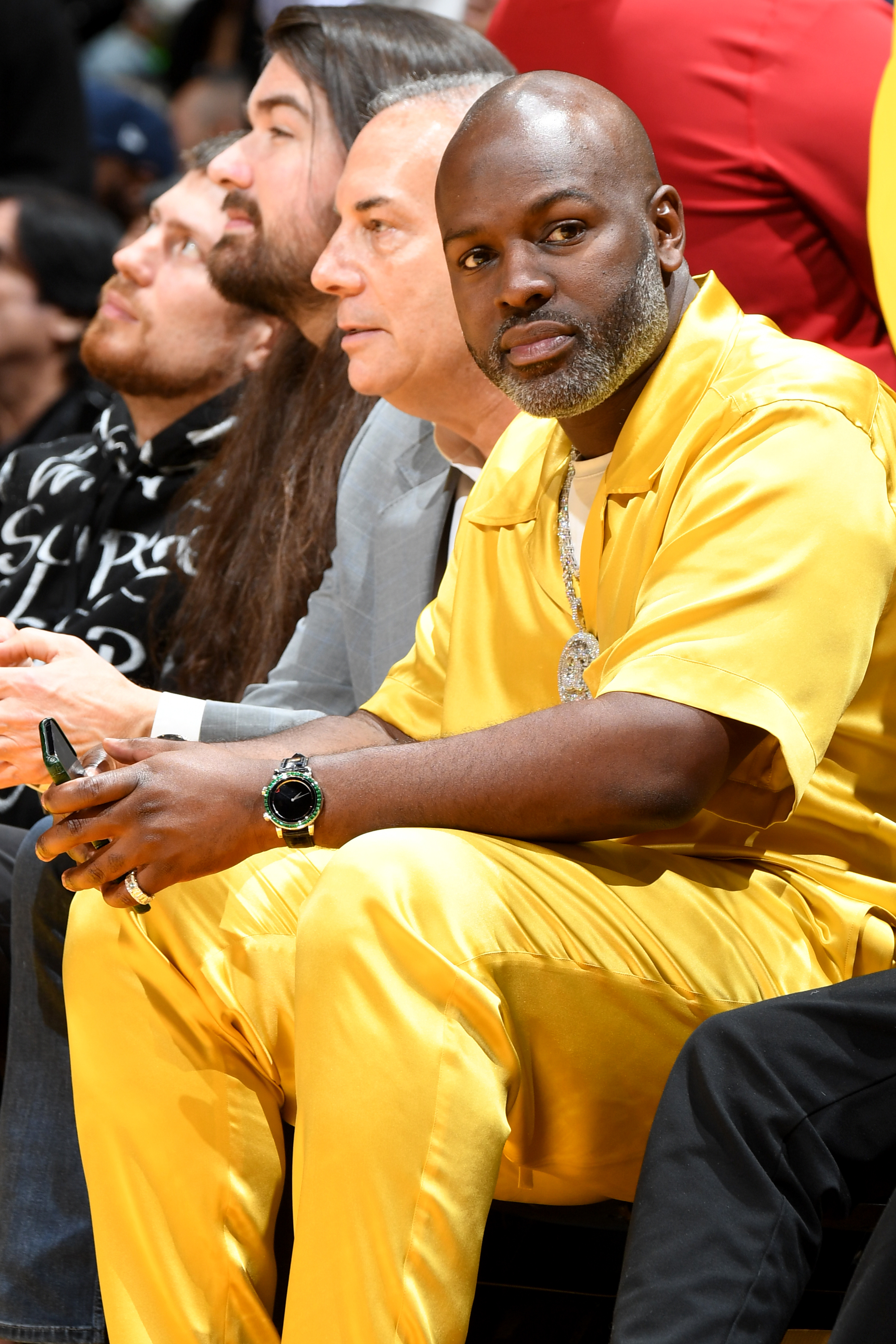 Close-up of Corey sitting in the audience at a sports event