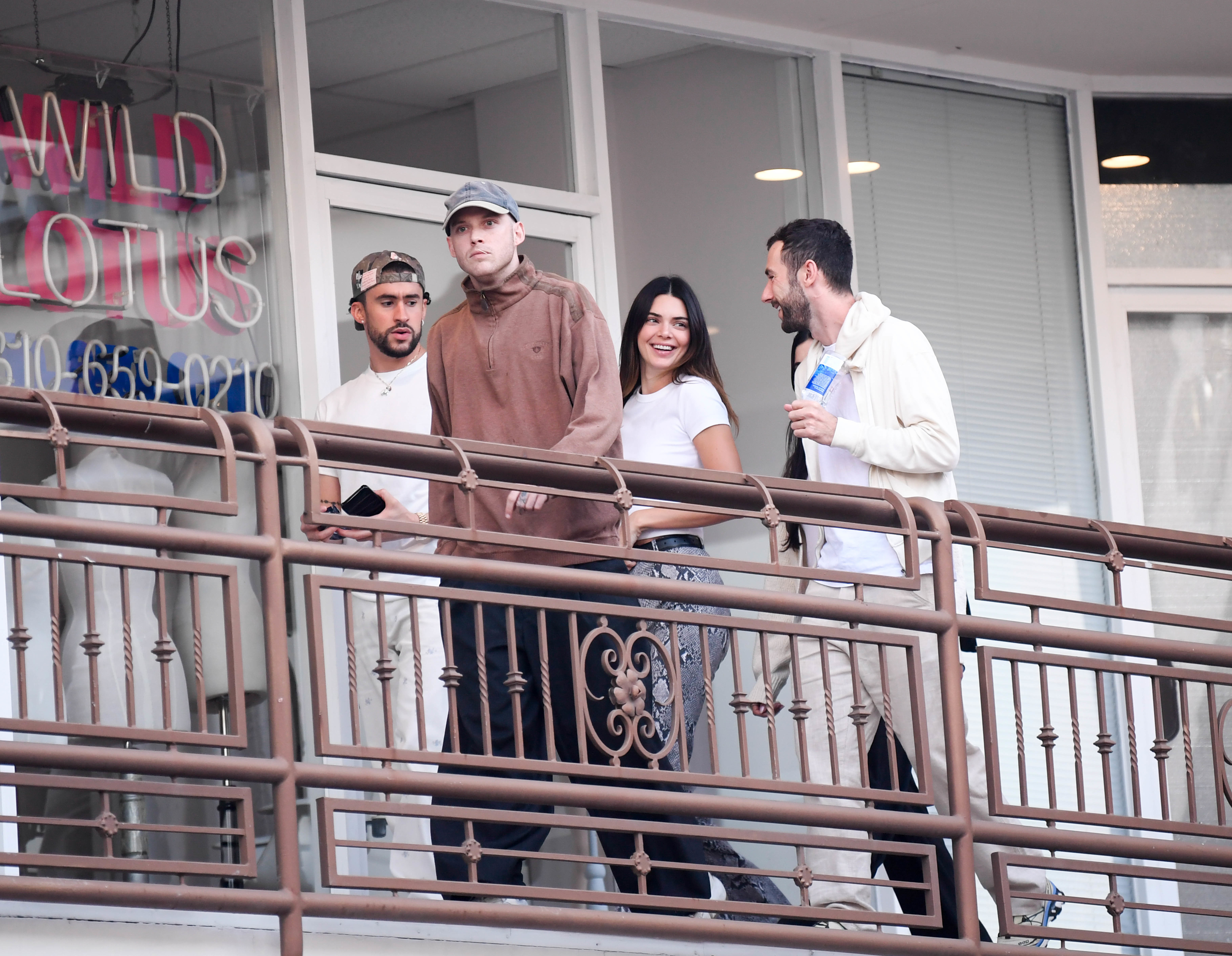 kendall and bad bunny walking with friends outside