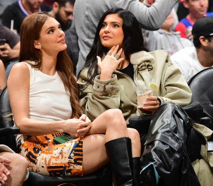 kylie and kendall sitting at a sports event