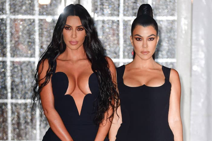 Close-up of Kim and Kourtney standing together and looking serious