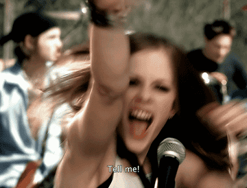 Avril Lavigne smashes a guitar and sings &quot;TELL ME!&quot;