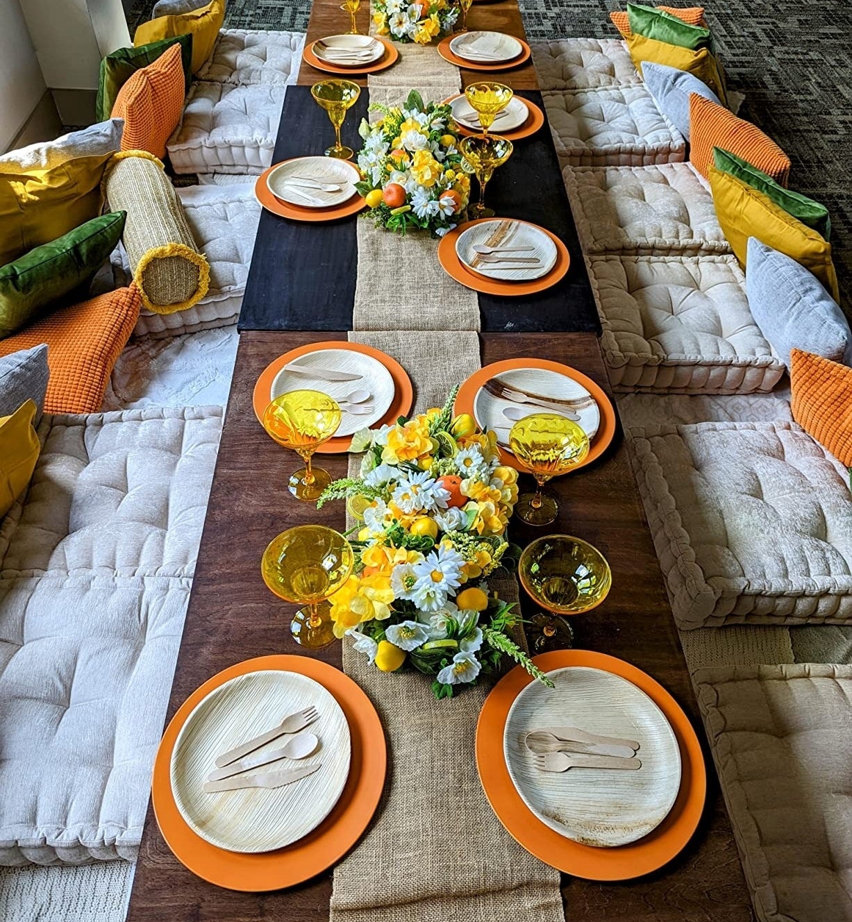 a reviewer photo of the floor pillows used with a dining table