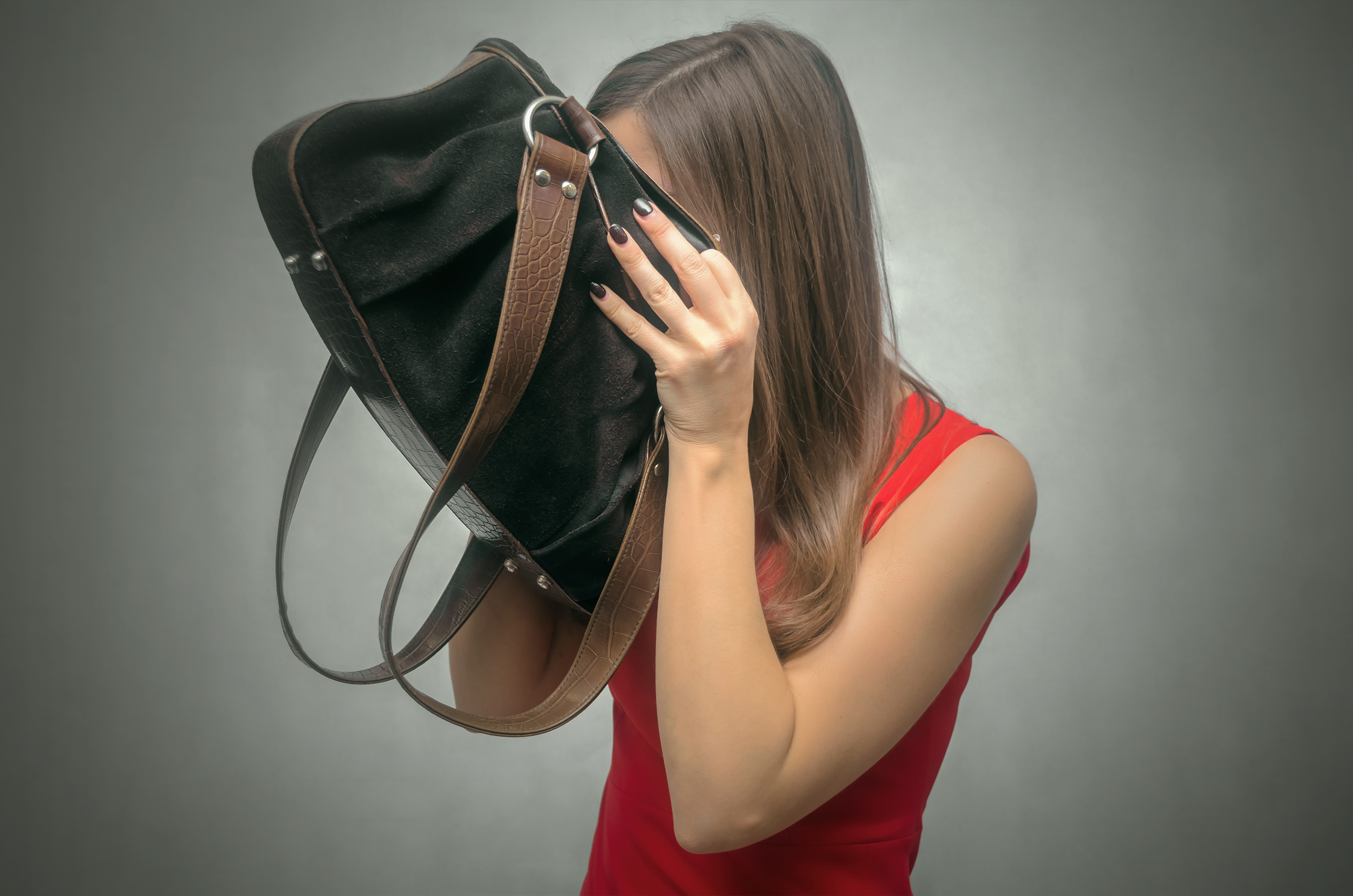 woman sticking her head in a bag