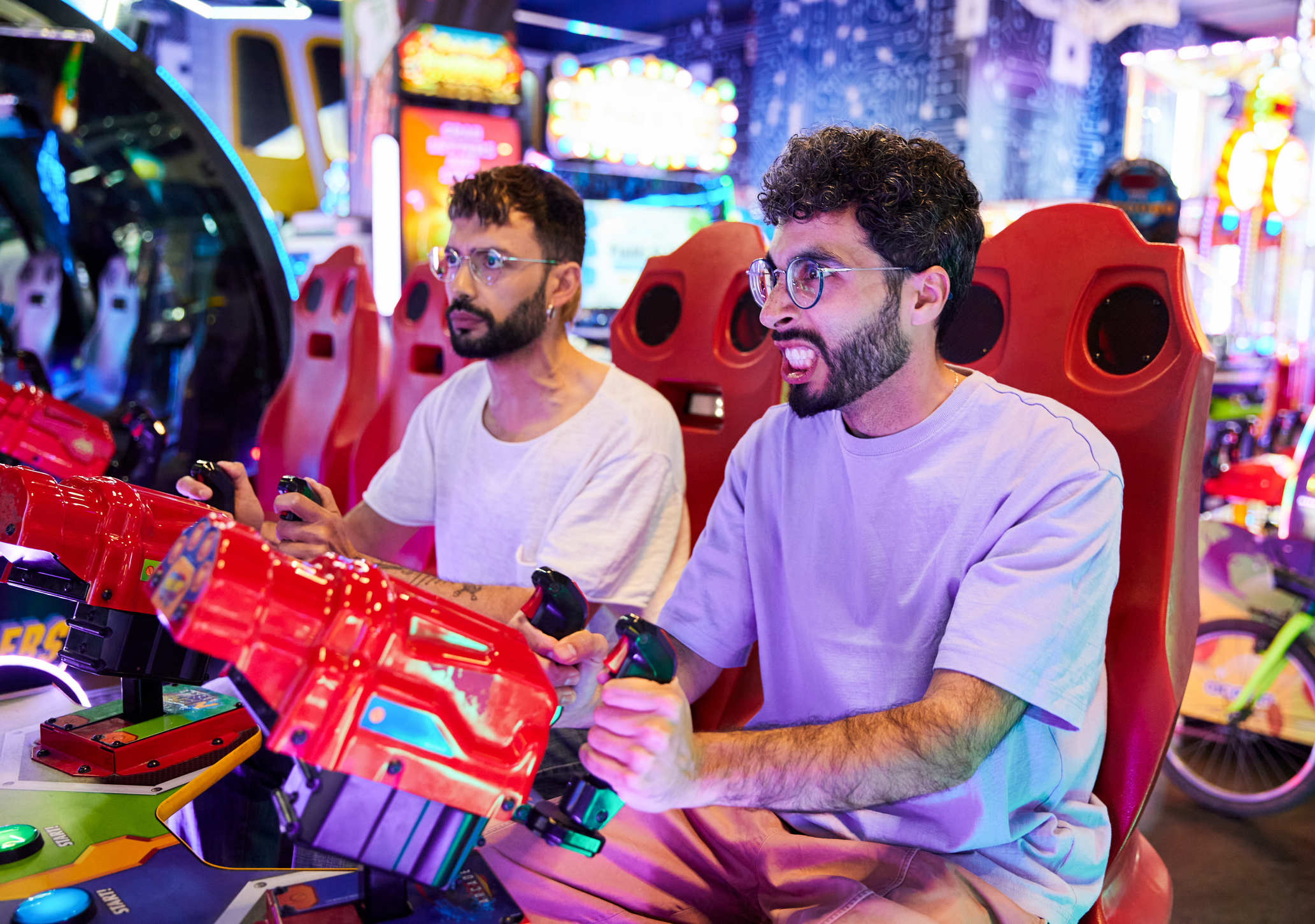 Men playing games in an arcade