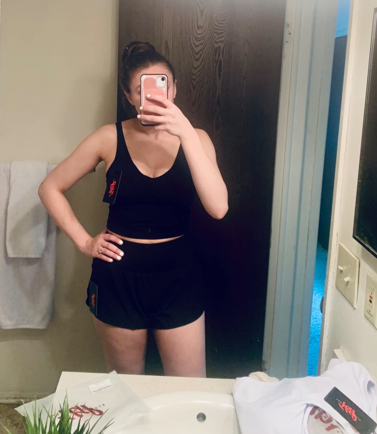 reviewer in the black tank with black shorts