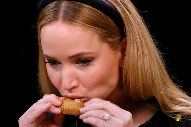 Jennifer Lawrence eating a chicken wing on Hot Ones