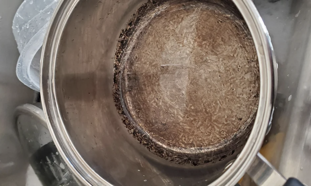 Burned rice in the bottom of a pan