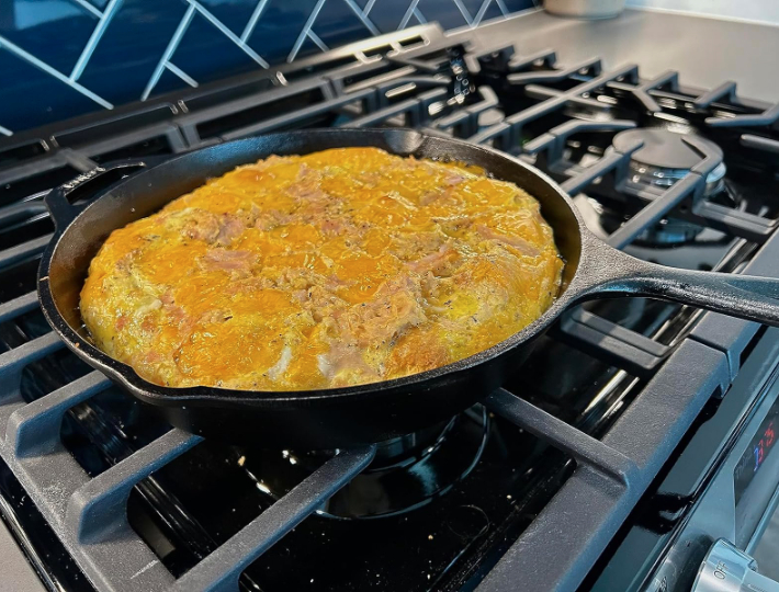 a cast iron pan cooking an omelette