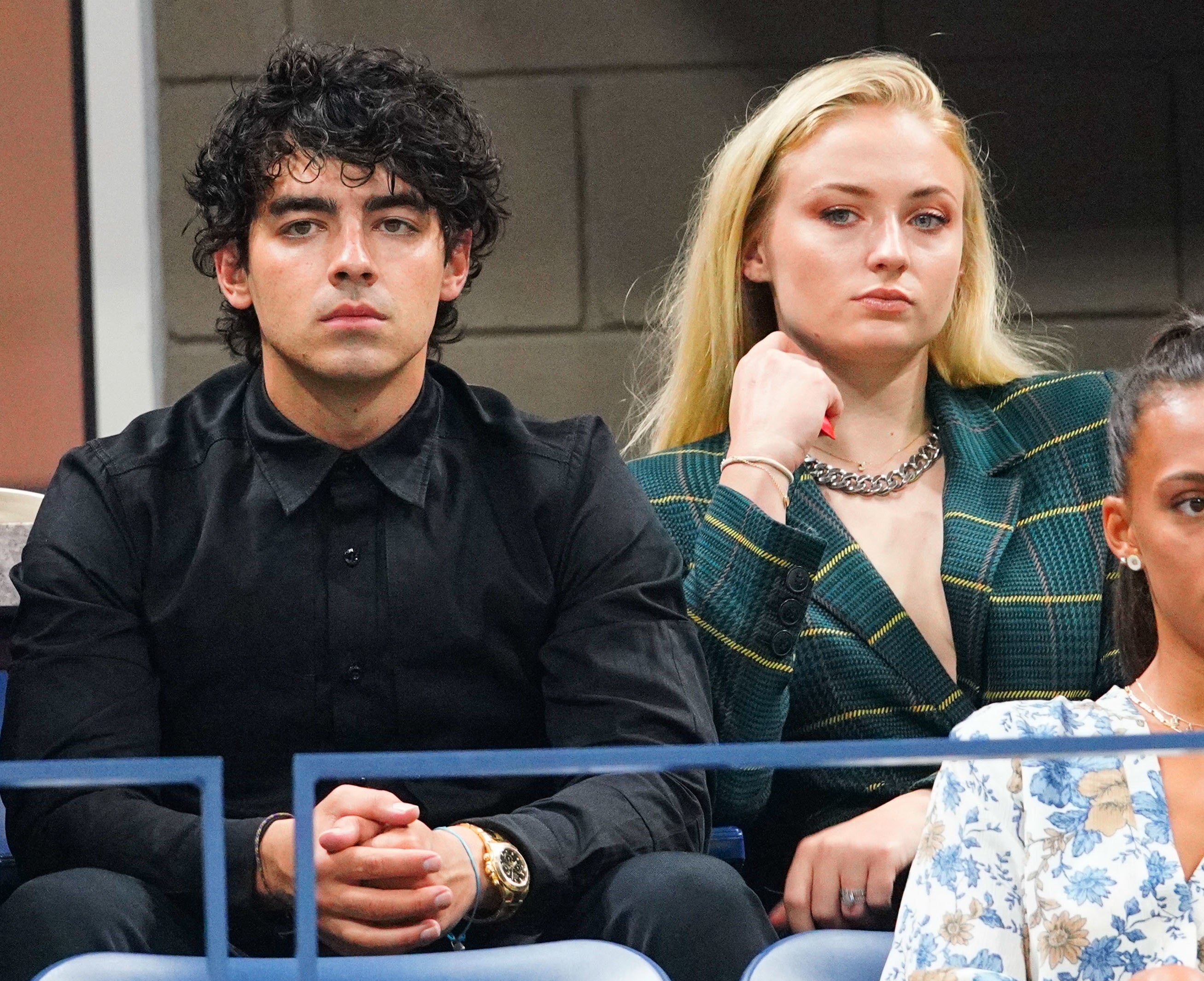 Close-up of Joe and Sophie sitting together in an audience
