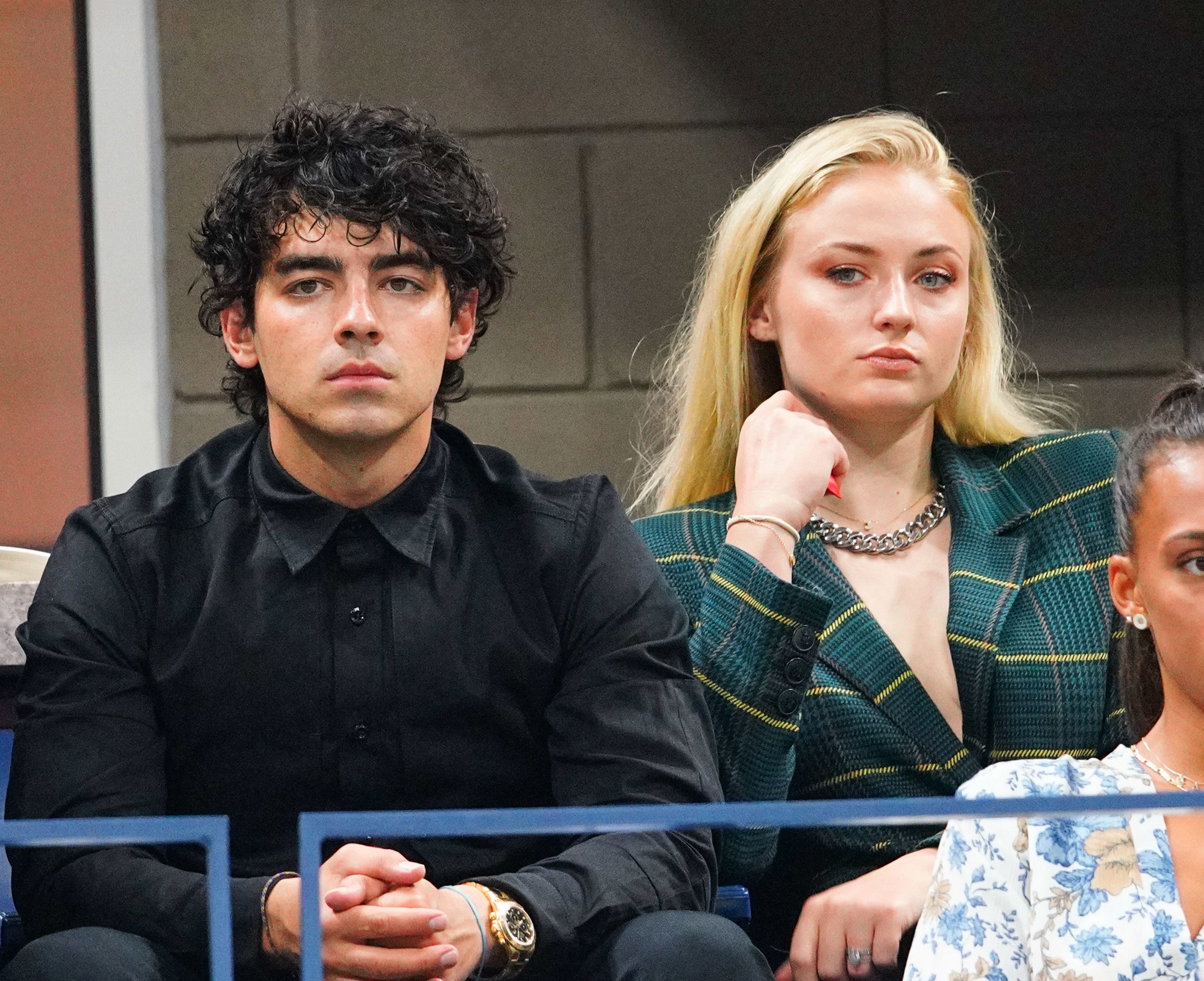 Close-up of Joe and Sophie sitting together in an audience