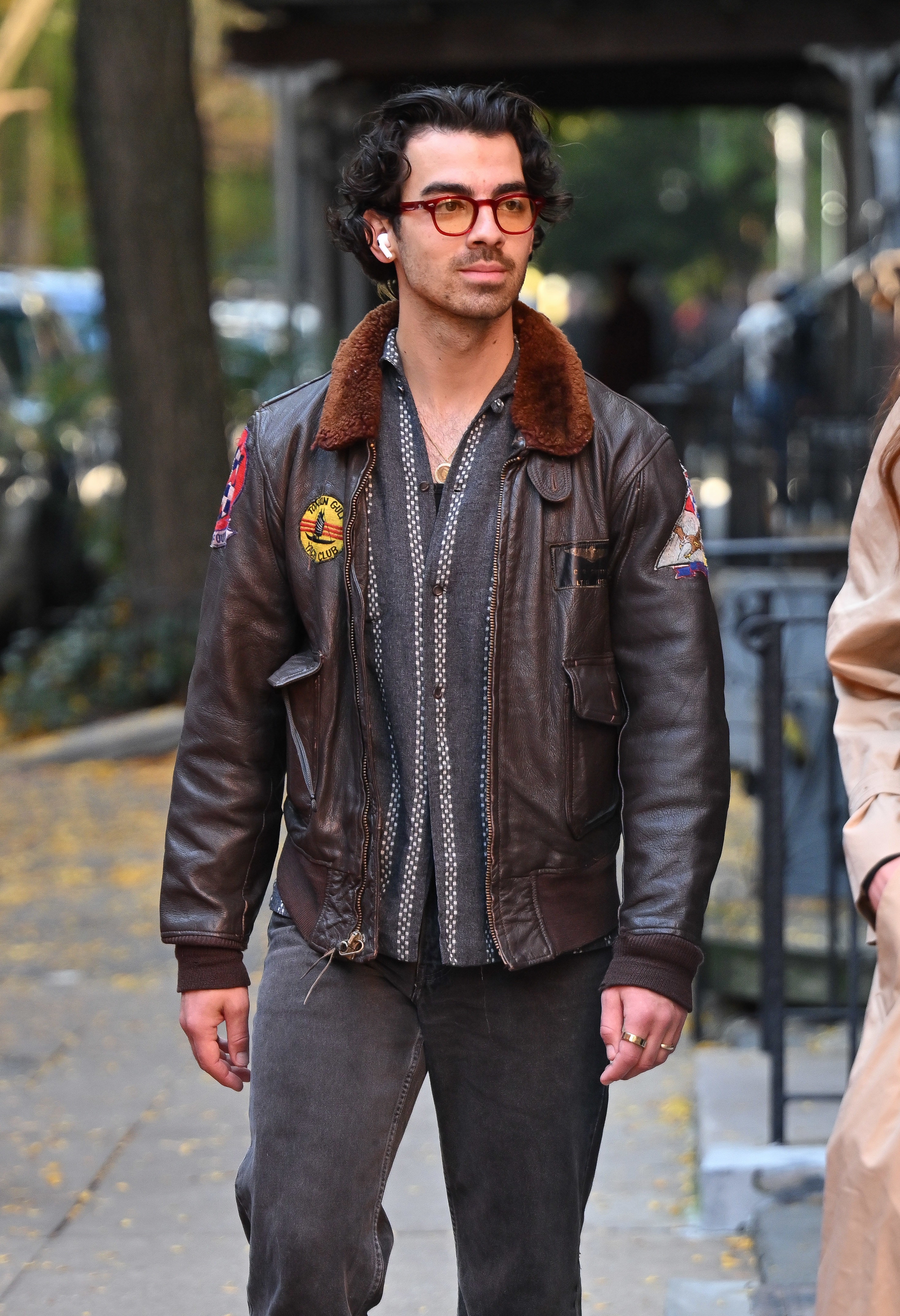 Close-up of Joe on the street in a short jacket and pants
