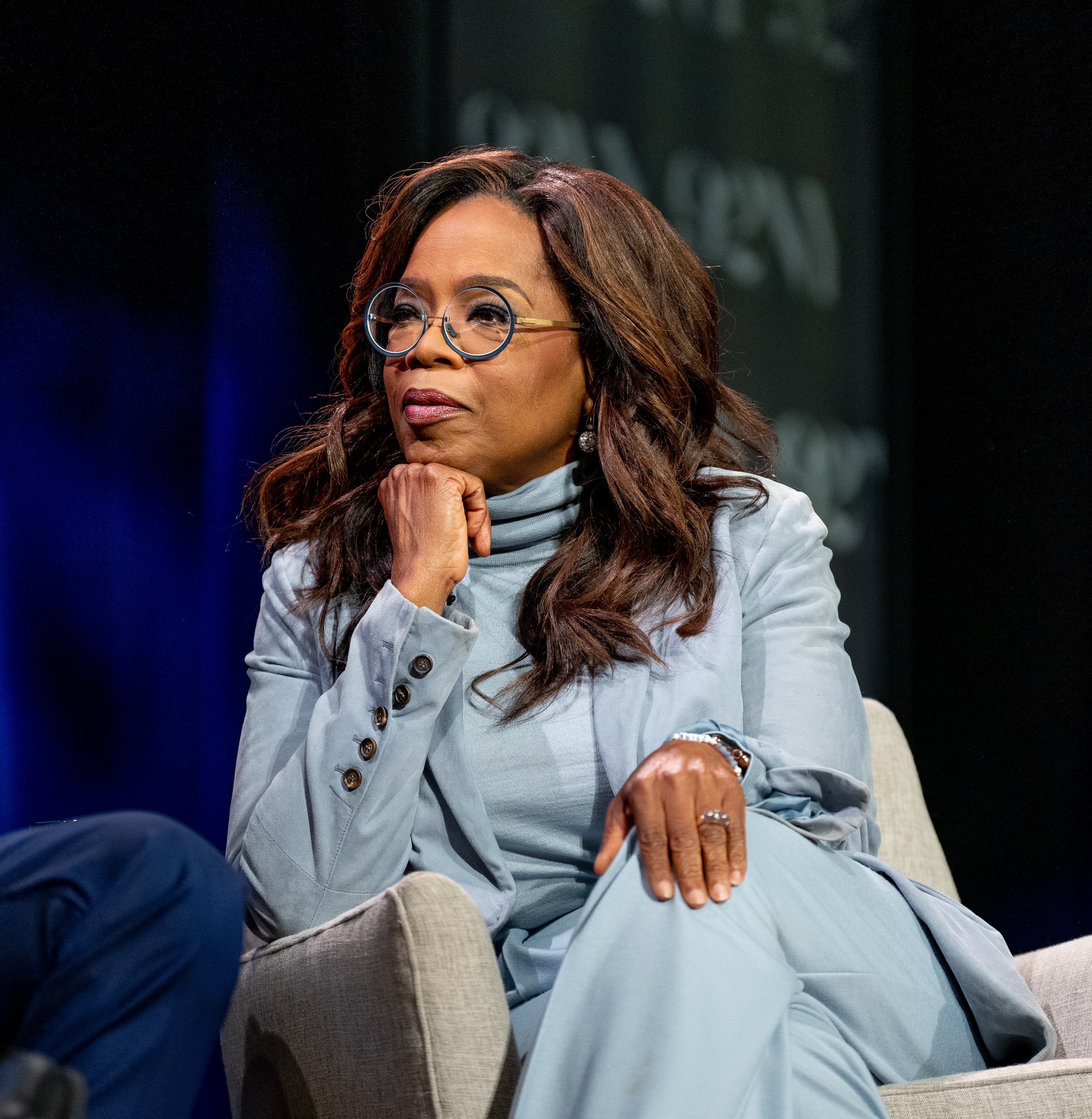 Close-up of Oprah sitting onstage