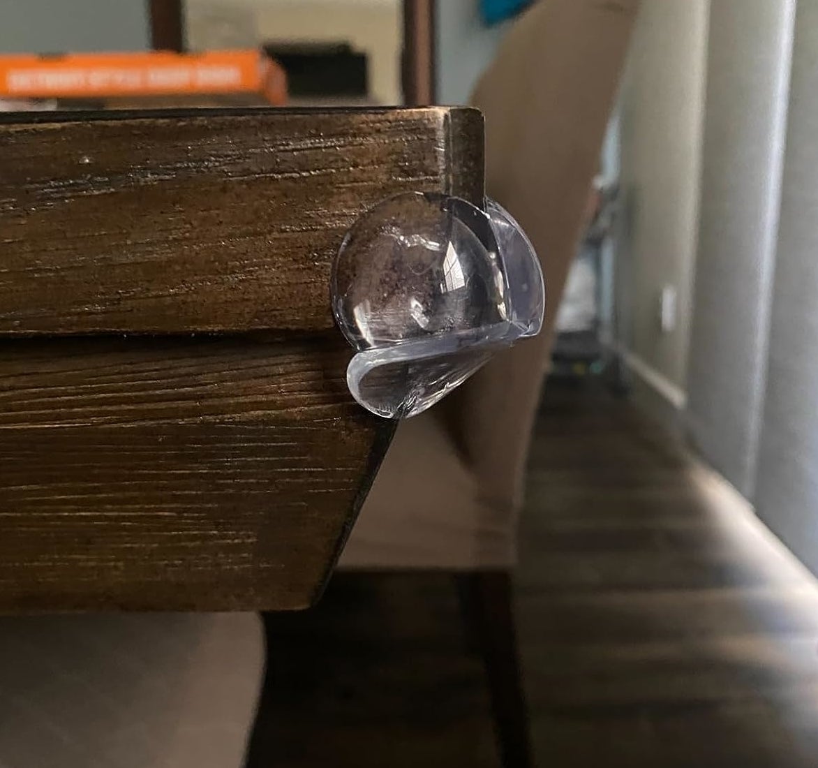 Reviewer’s photo of clear corner protector attached to a dining table