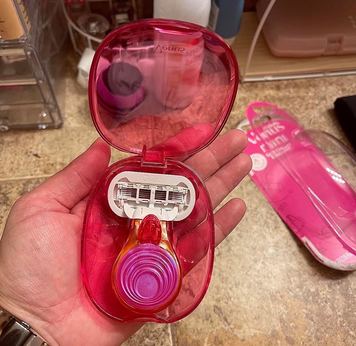 Reviewer’s photo of pink venus on the go razor in an opened container