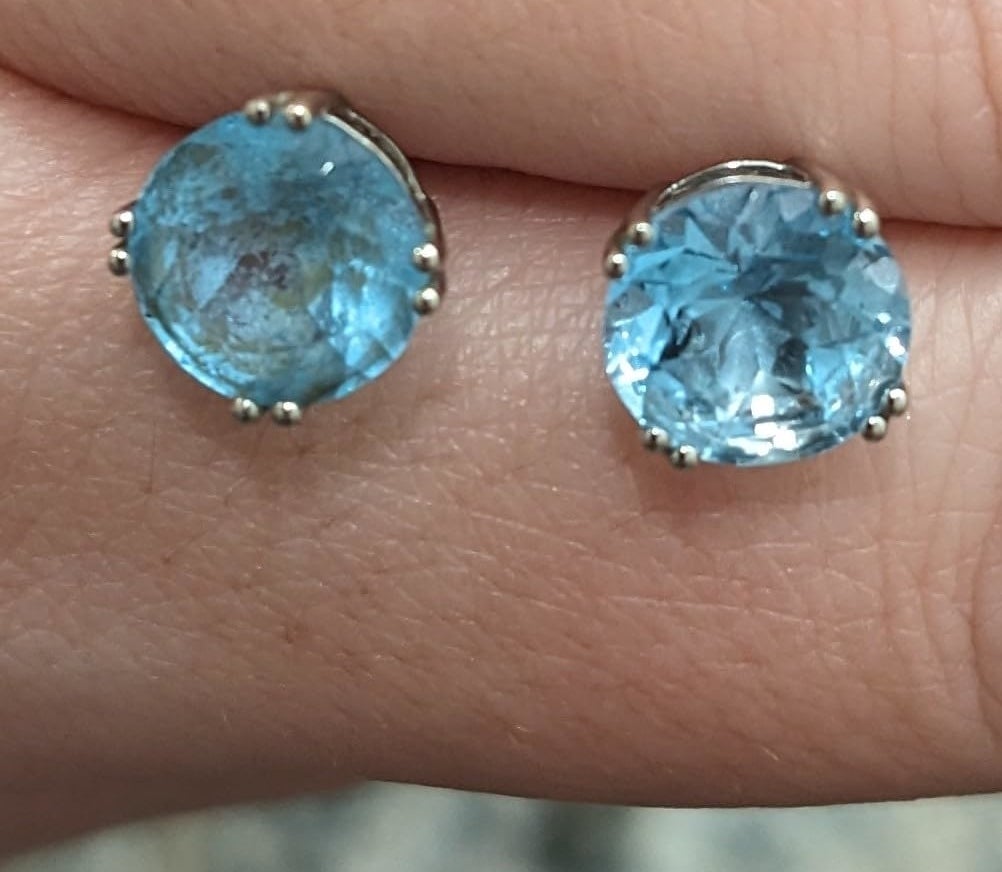 Reviewer’s photo of a pair of blue stud earrings