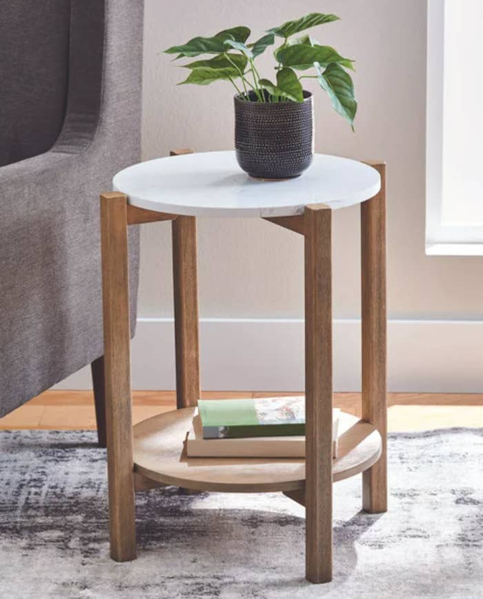 small side table with circular marble tabletop with wooden legs