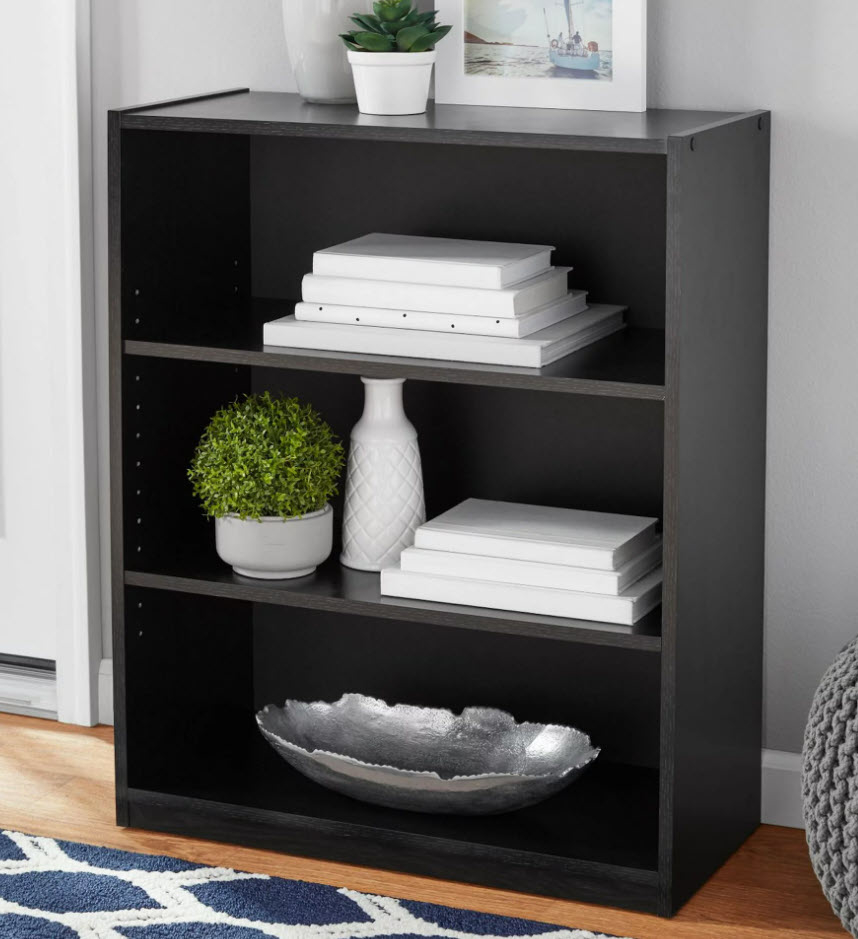 black accent shelf with three levels and decor